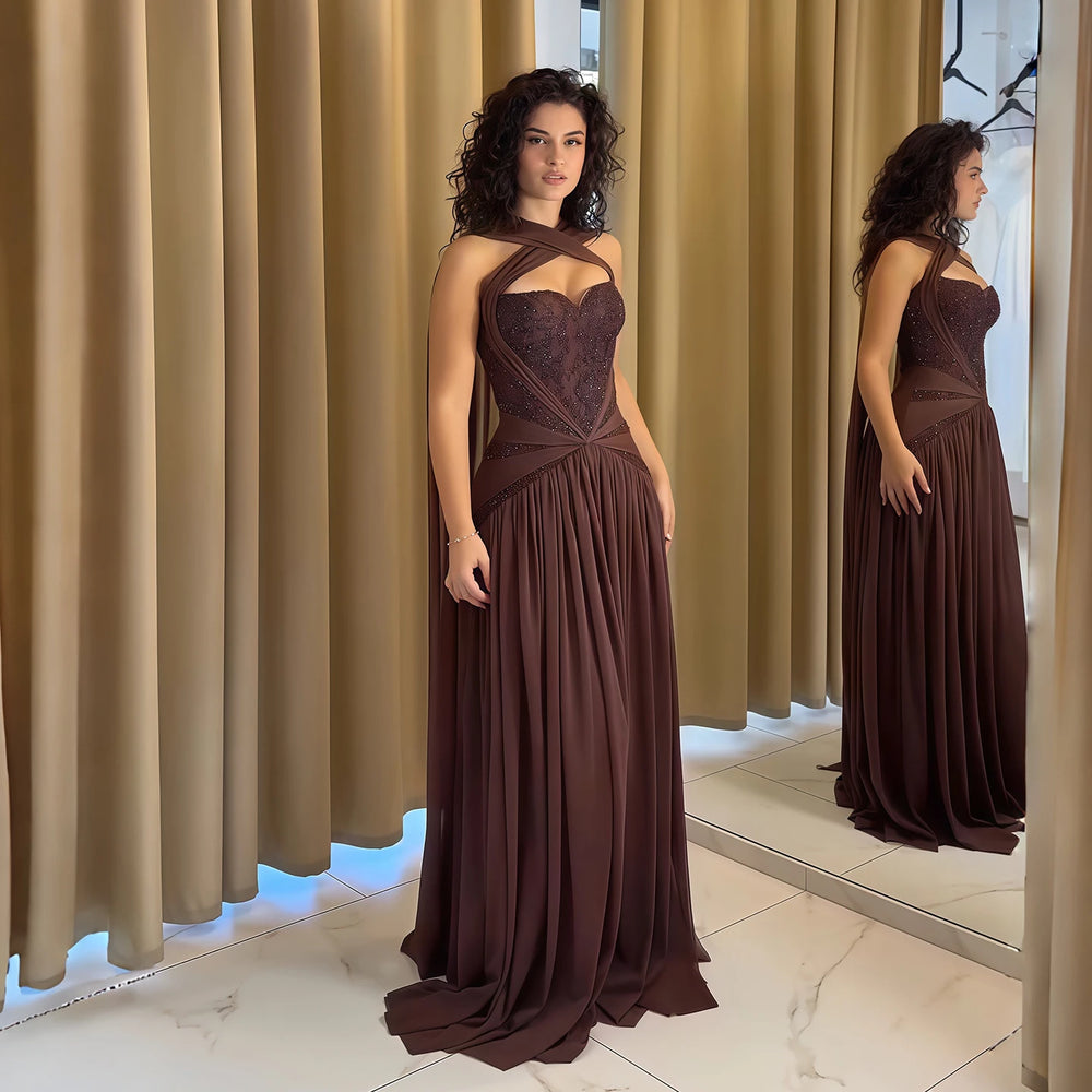 Chiffon evening dress with embroidered halter neckline worn by a model.