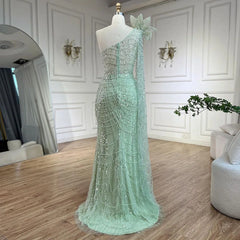   Mannequin  displaying the sage green mermaid evening gown, showcasing its flattering silhouette and flowing train. Golden Atelier 3