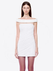 Model wearing off shoulder ruched mini dress against white background