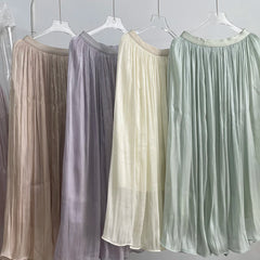 Four sheer skirts in different colors hanging on a rack.