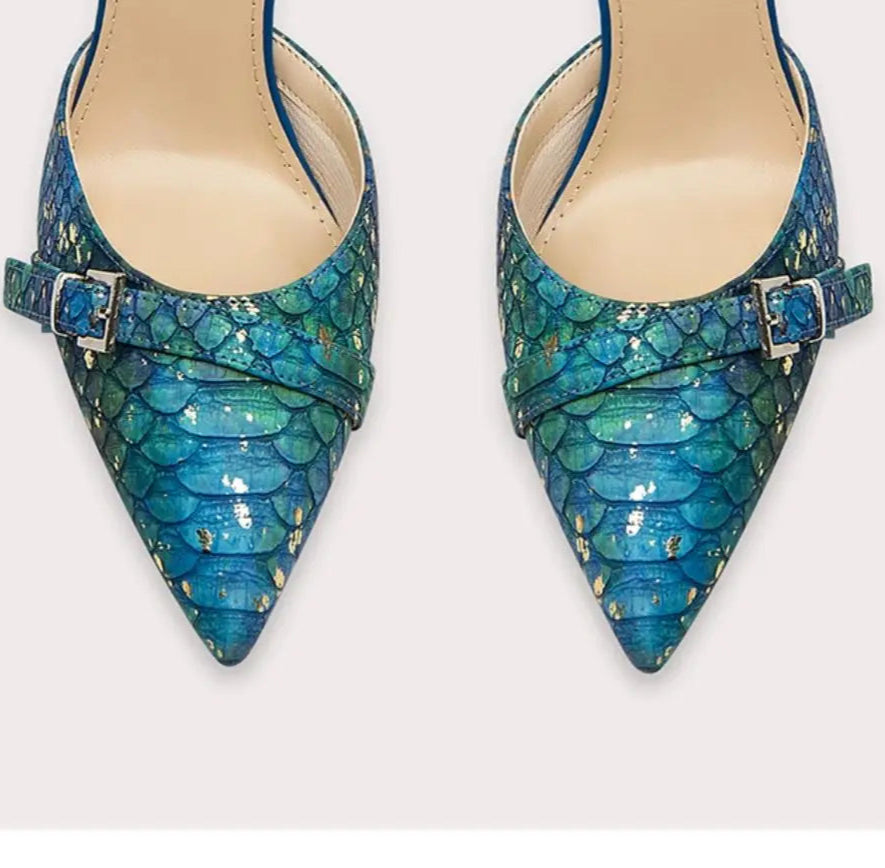 Pair of blue pointed-toe shoes with snake skin pattern on a white background
