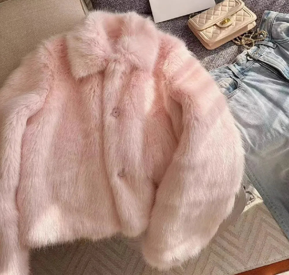 Women’s pink shaggy faux fur coat with turn-down lapel and full sleeves.