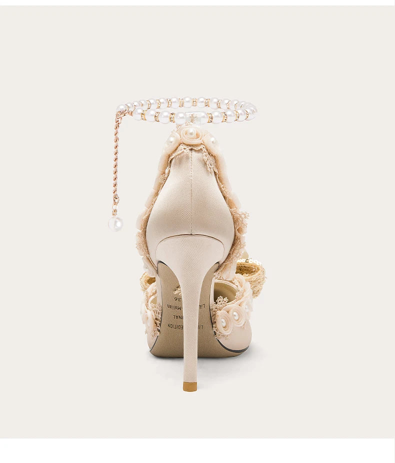 Beige high-heeled shoe with decorative elements on a white background