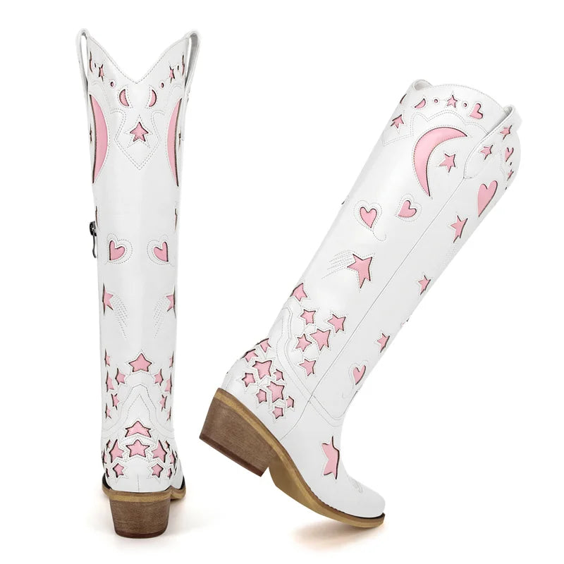 White cowboy boots with pink star and heart patterns on a white background