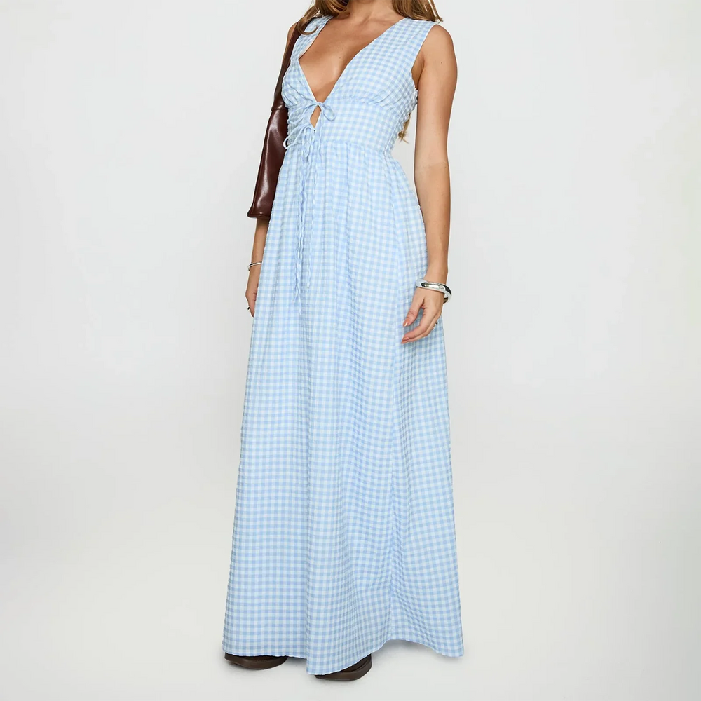 Woman wearing a light blue checkered dress on a white background