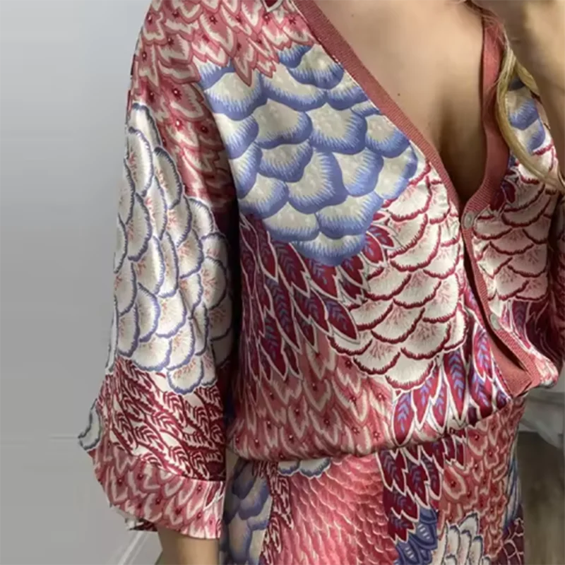 Colorful patterned garment with long sleeves on a plain background