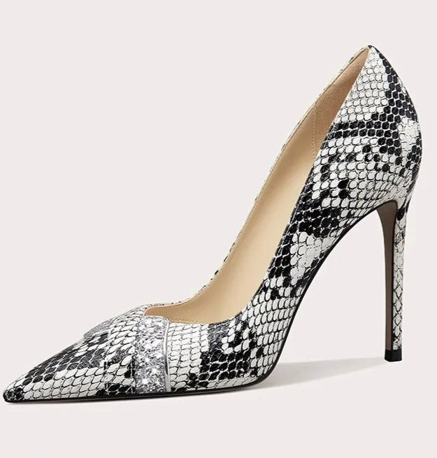 High-heeled shoe with snake print on a light gray background