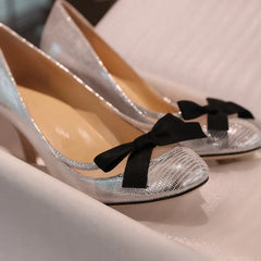 Silver bow high heels close-up detail