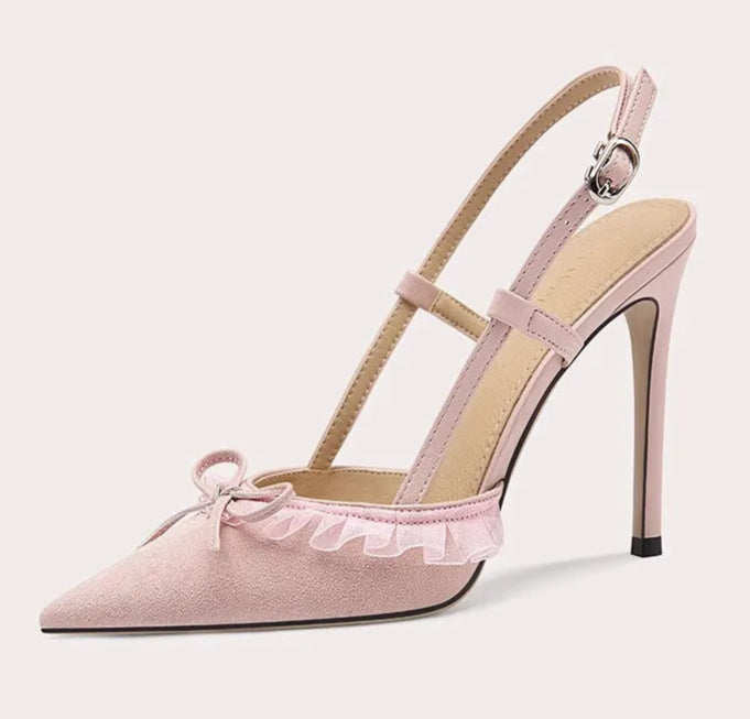 Pink high-heeled shoe with bow detail on a light gray background