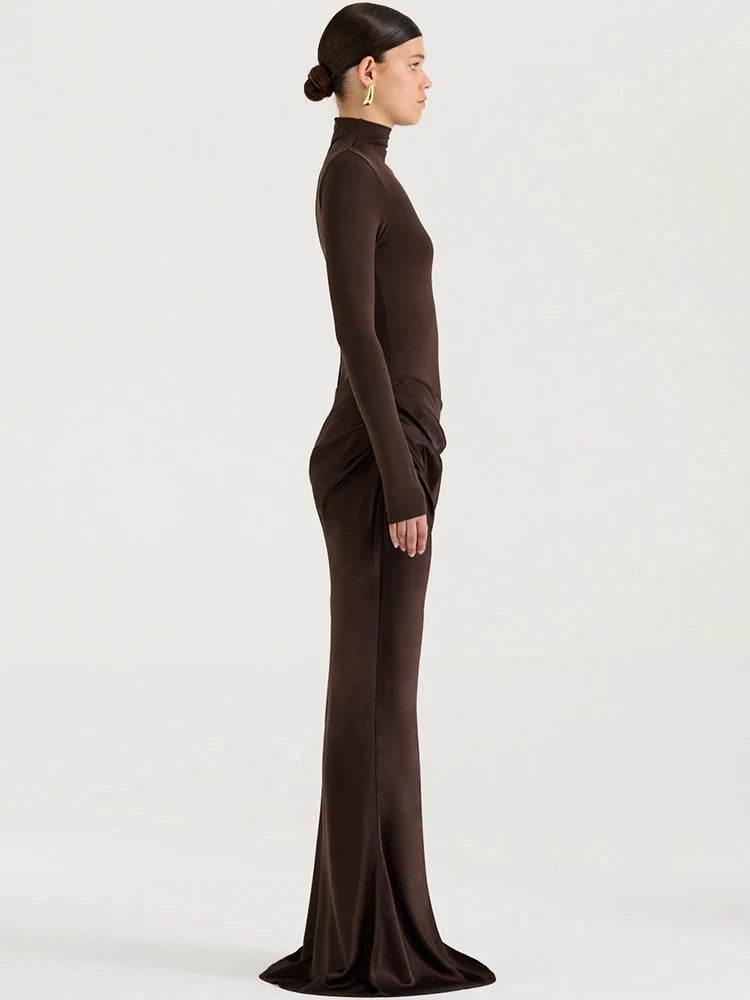 Woman wearing a brown long-sleeve dress against a white background