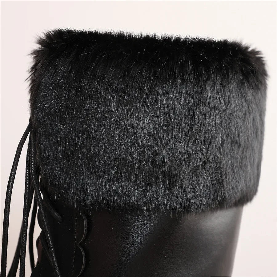 Black fur-trimmed boot on a light gray background