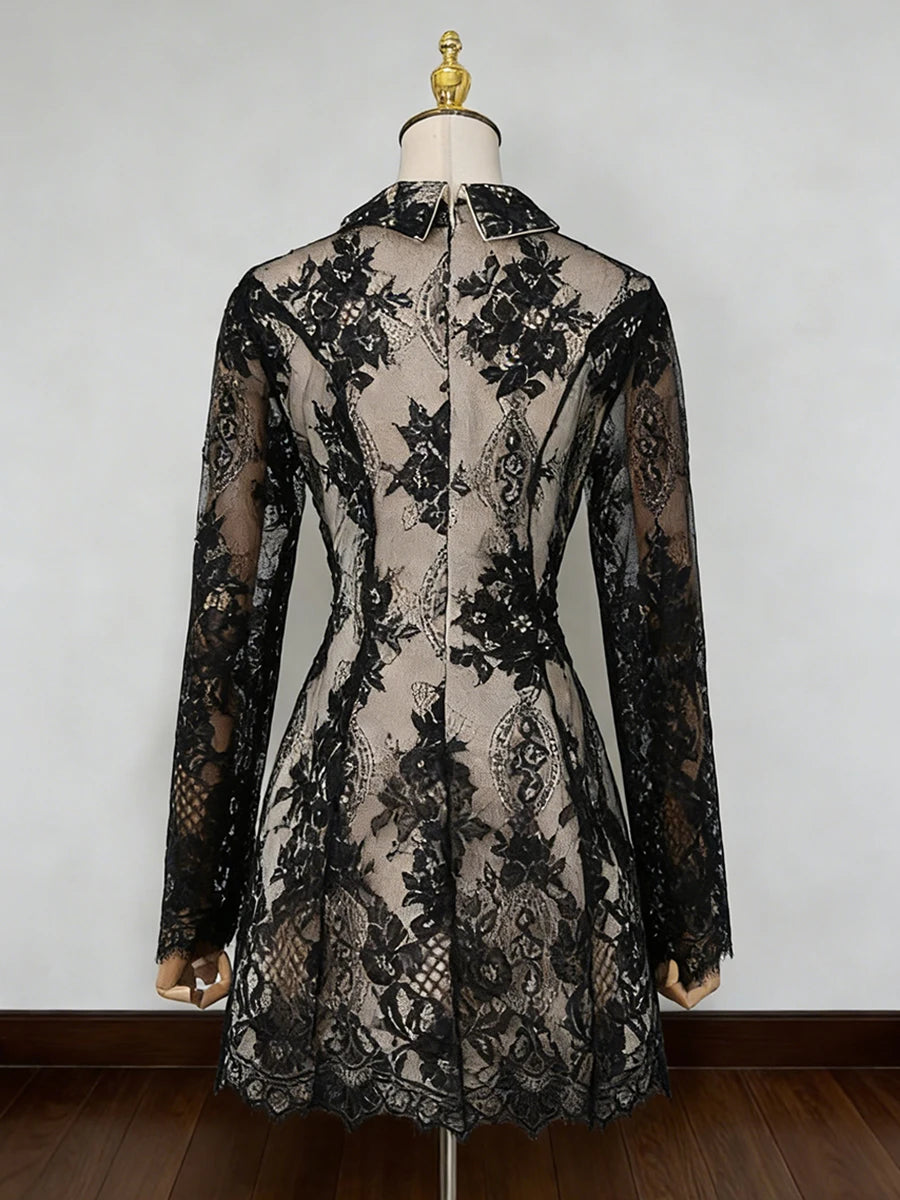 Black lace dress on a mannequin against a white background