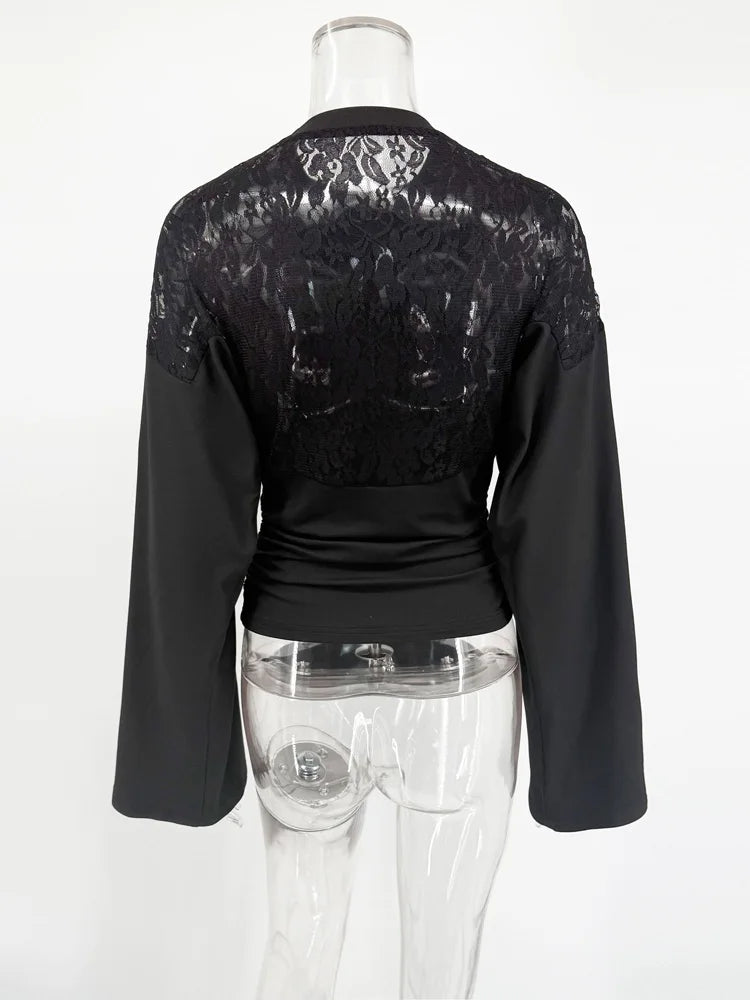 Black long-sleeve top with lace detailing on a mannequin against a white background