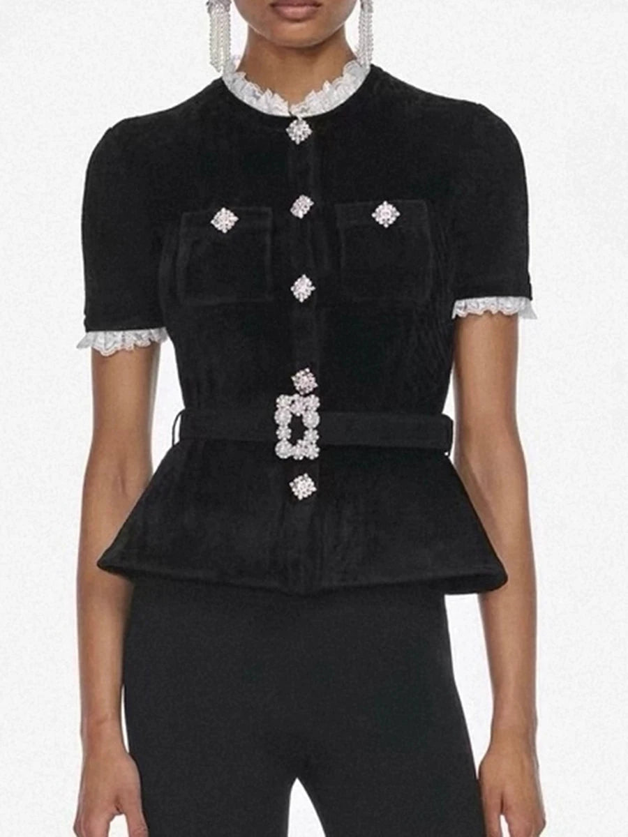 Black peplum top with white embellishments