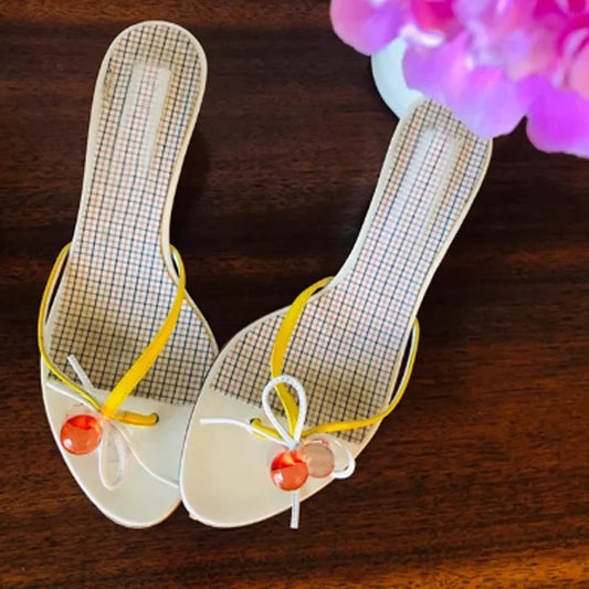 Pair of kitten heel mules with yellow ribbon and beaded embellishments