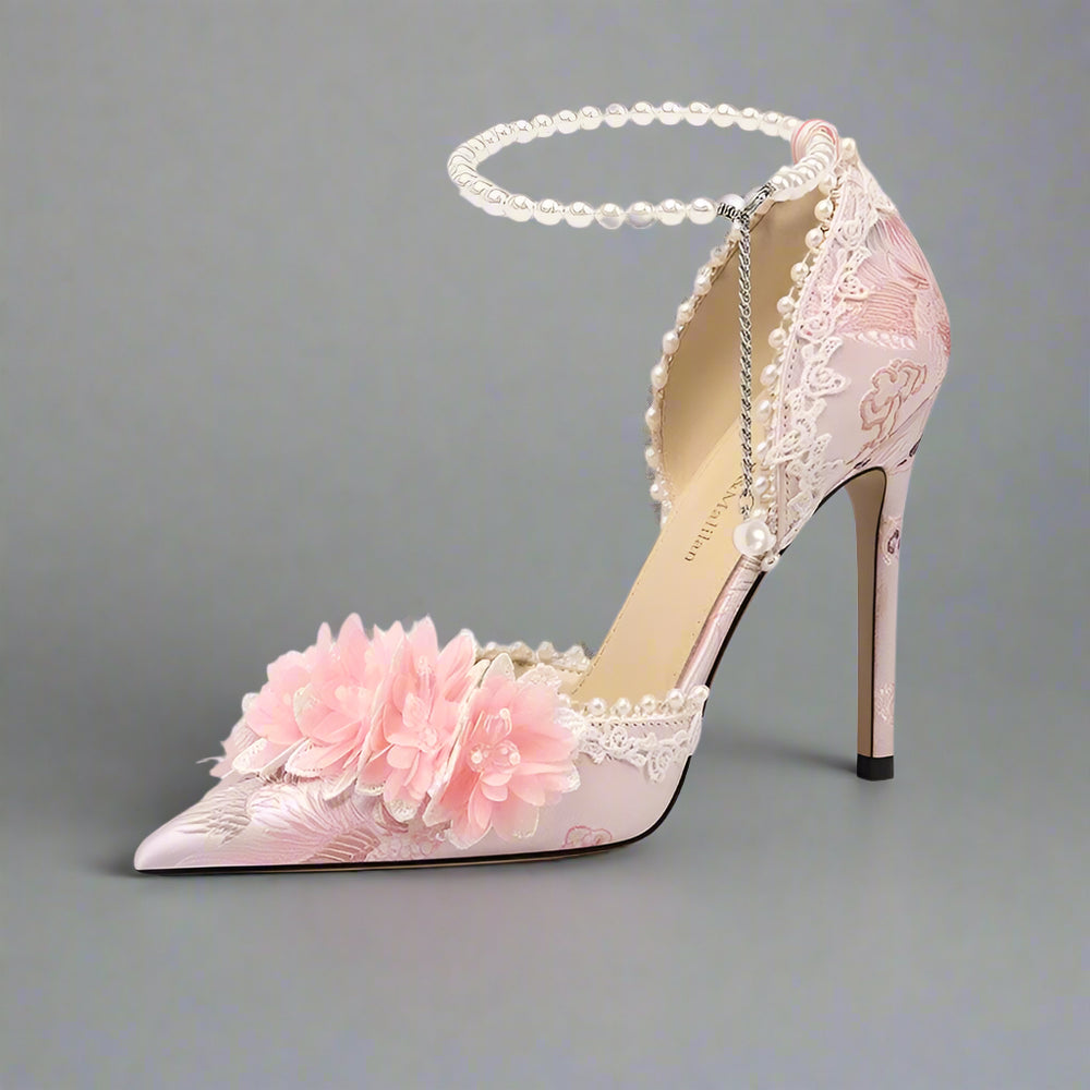 Pink high-heeled shoe with floral design on a light background