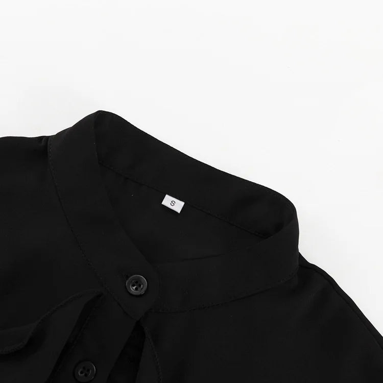 Close-up of a black shirt collar with a button on a white background