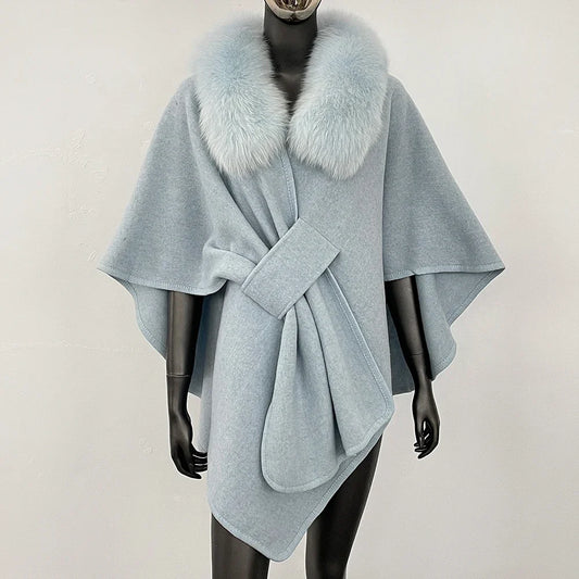 Light blue knit poncho with a soft blue fur collar and knotted front.