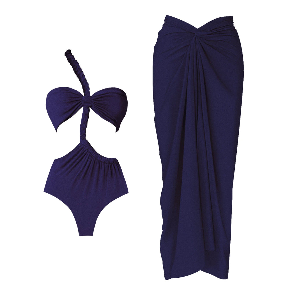 Close-up view of a navy one-piece swimsuit with a one-shoulder strap and a draped maxi skirt, shown as a set.