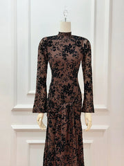 Lace dress with long sleeves on a mannequin against a white wall