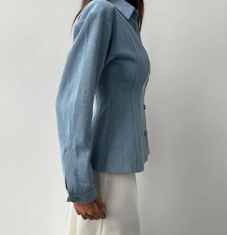 Blue blazer worn by a person on a plain background