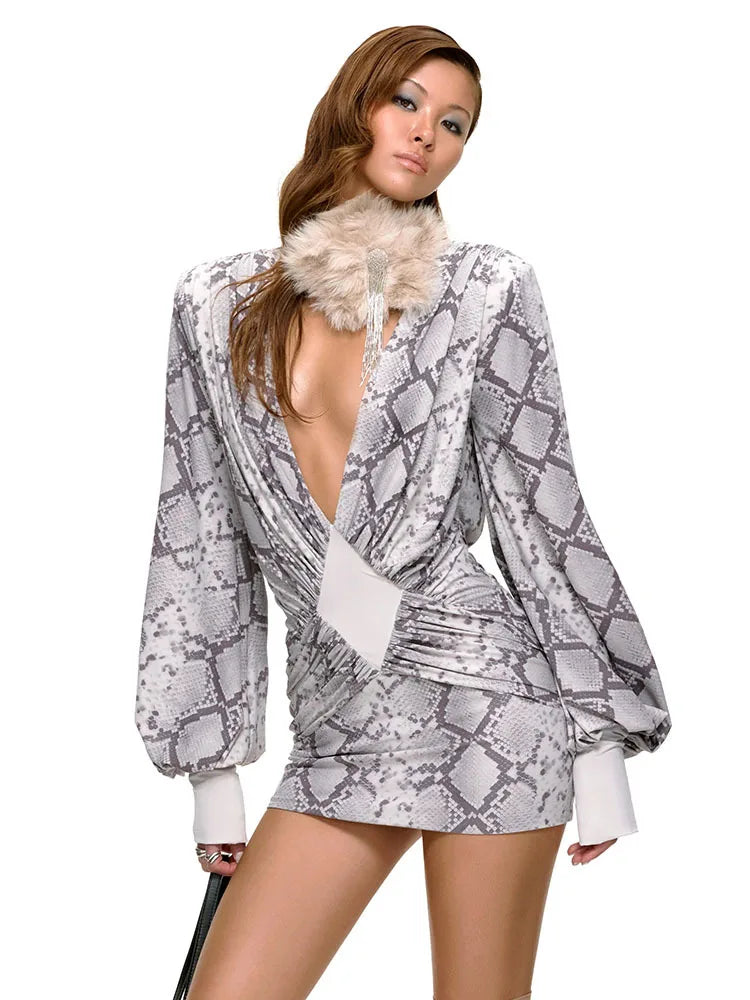 Woman wearing a snake print outfit with a fur collar on a white background