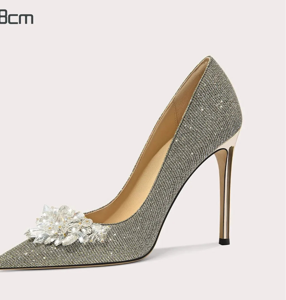 High-heeled shoe with decorative flower on a white background