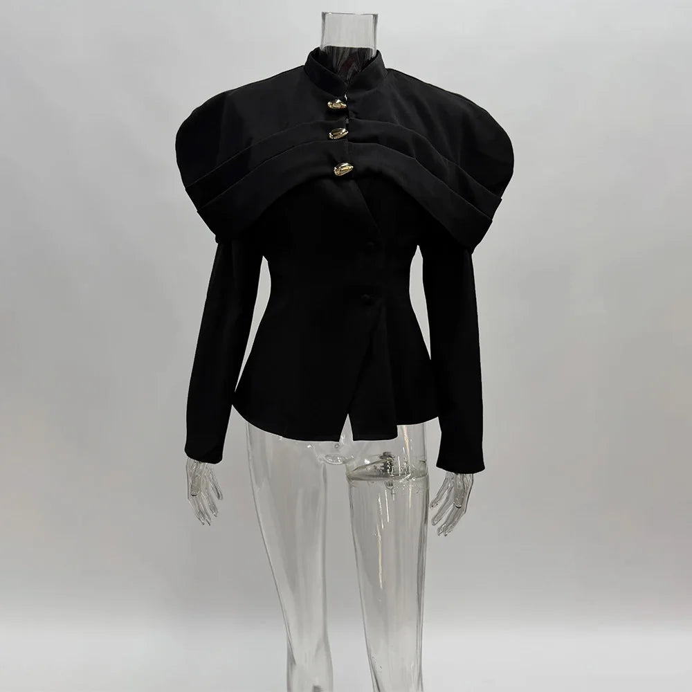 Black peplum top on a mannequin against a gray background