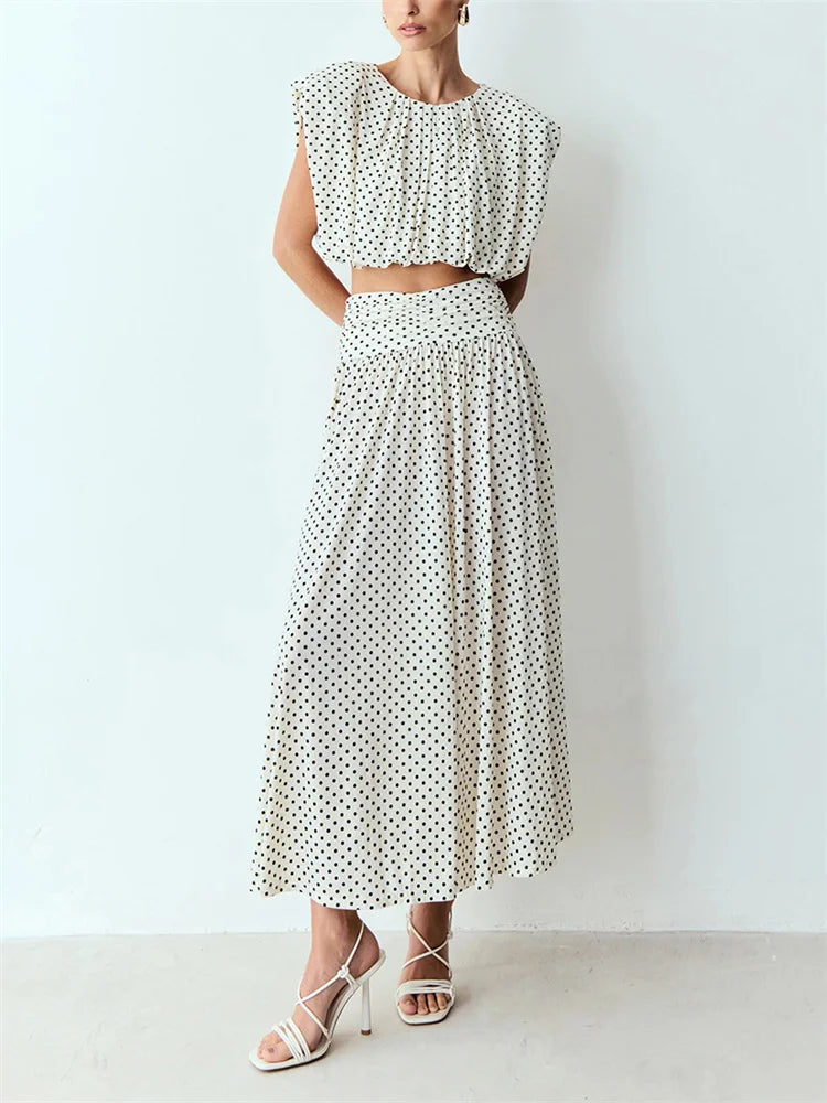 White polka dot sleeveless crop top and flowing maxi skirt on a mannequin