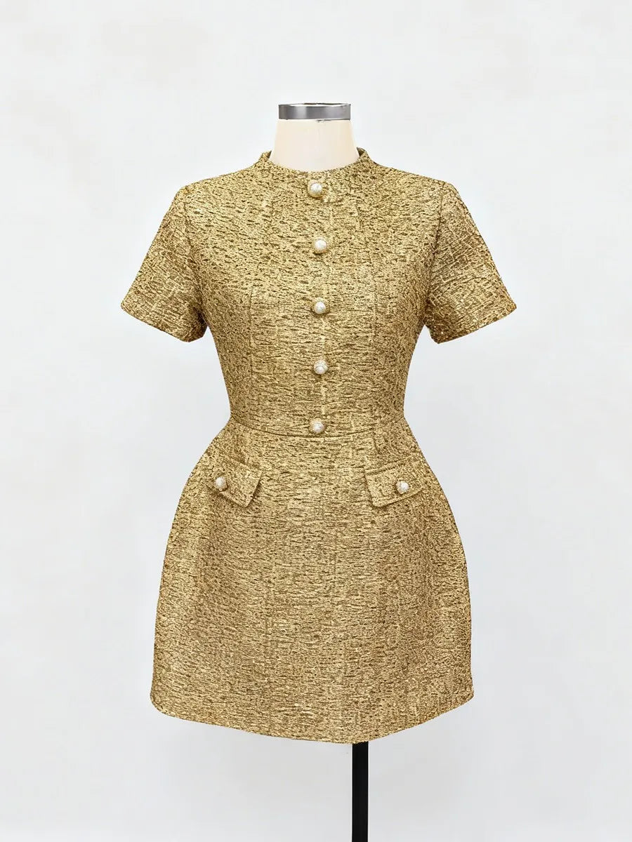 Gold textured dress on a mannequin against a white background