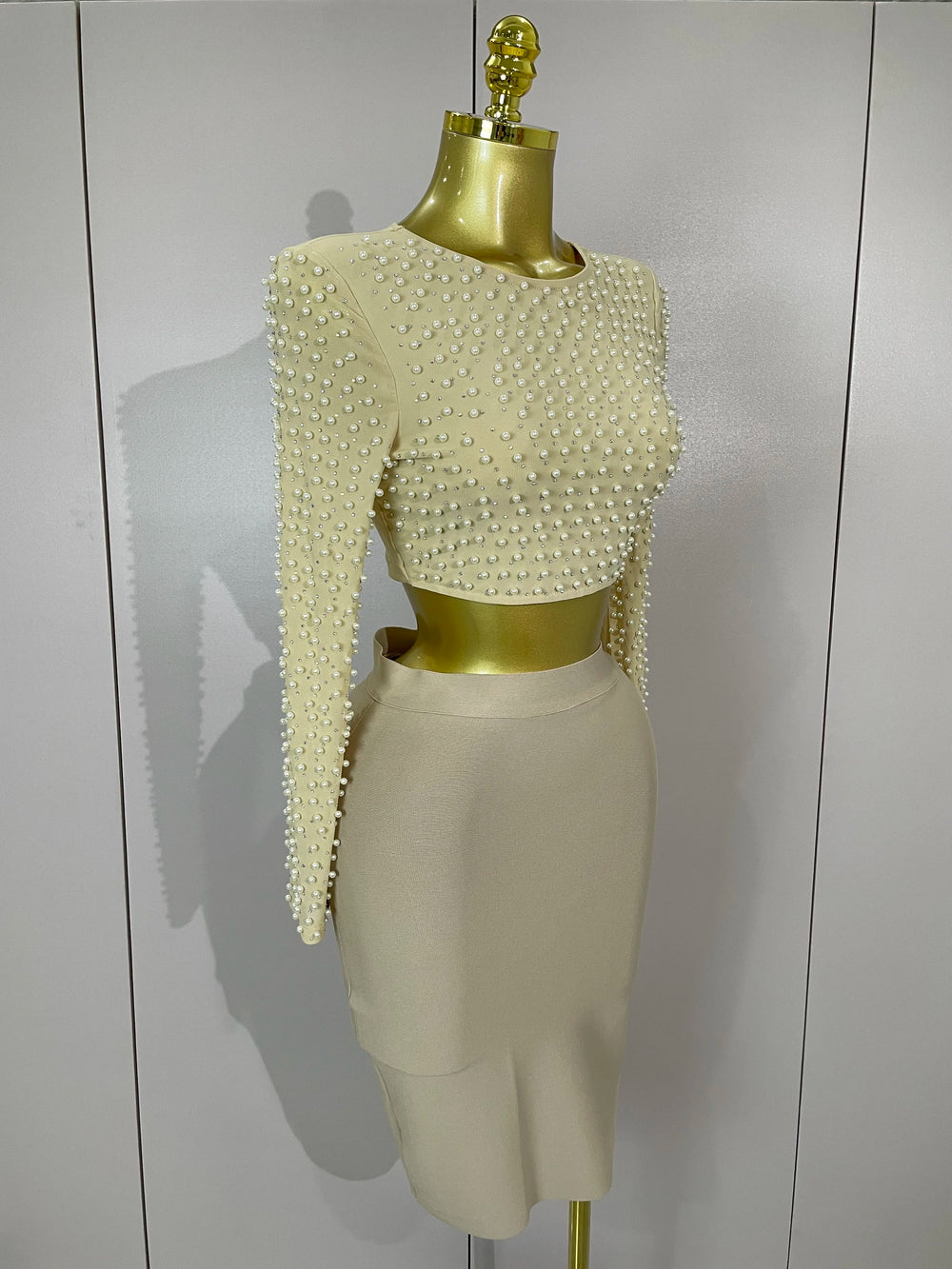 Beige mesh pearl top with matching midi bandage skirt set.