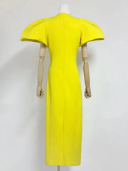 Yellow dress on a mannequin against a white background