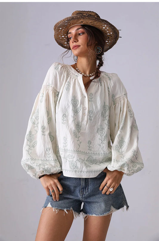 V-neck embroidered cotton blouse with green floral details and lantern sleeves