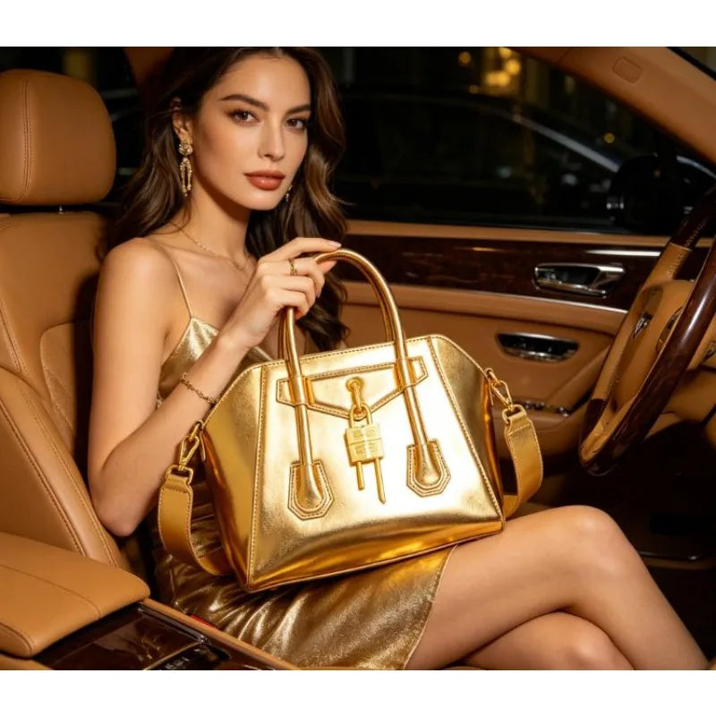 Gold metallic structured lock bag held by a woman in a car