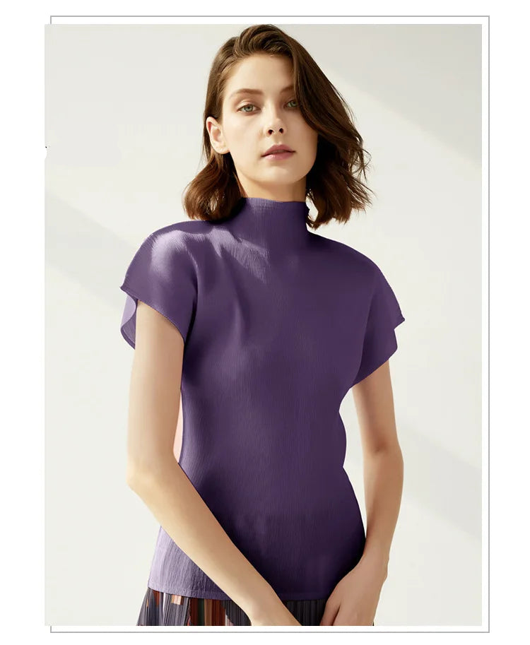 Woman wearing a purple turtleneck top on a plain background