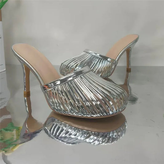 Silver metallic stiletto mule heel with open toe and caged design