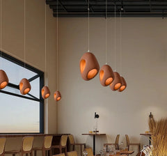 A modern Wabi-sabi style LED chandelier illuminating a cozy restaurant interior. 4