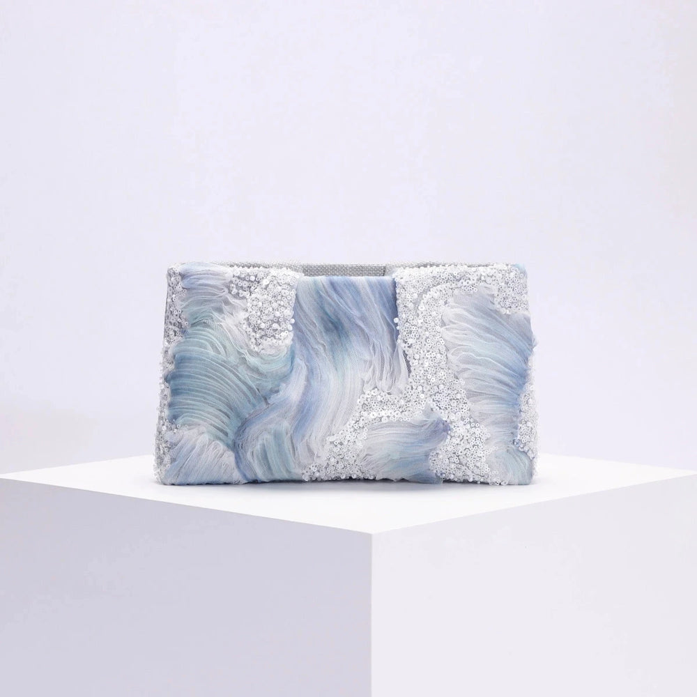 Clutch bag with blue and gray marbled pattern on a white background