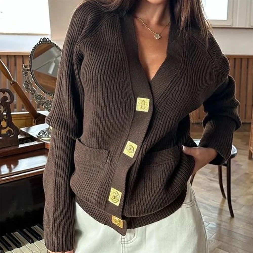 Brown ribbed sweater with gold buttons worn by a person indoors.