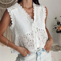 White lace top worn by a person with a neutral background