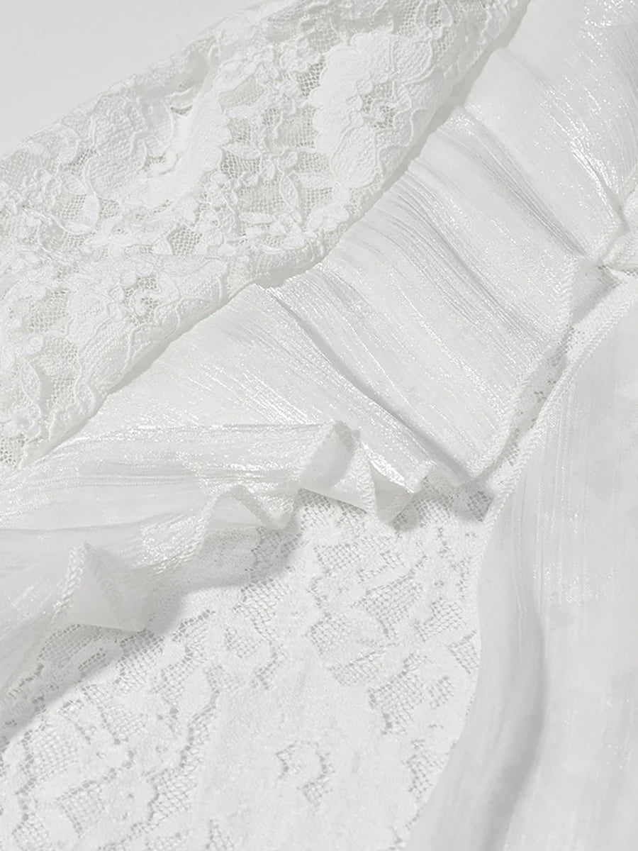 Close-up of a white lace garment with a bow detail.