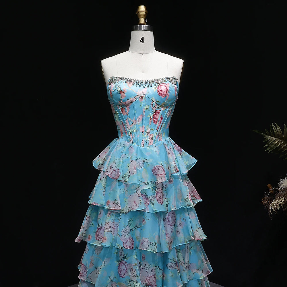 Floral tiered dress on a mannequin against a black background