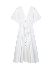 White dress with black buttons on a white background