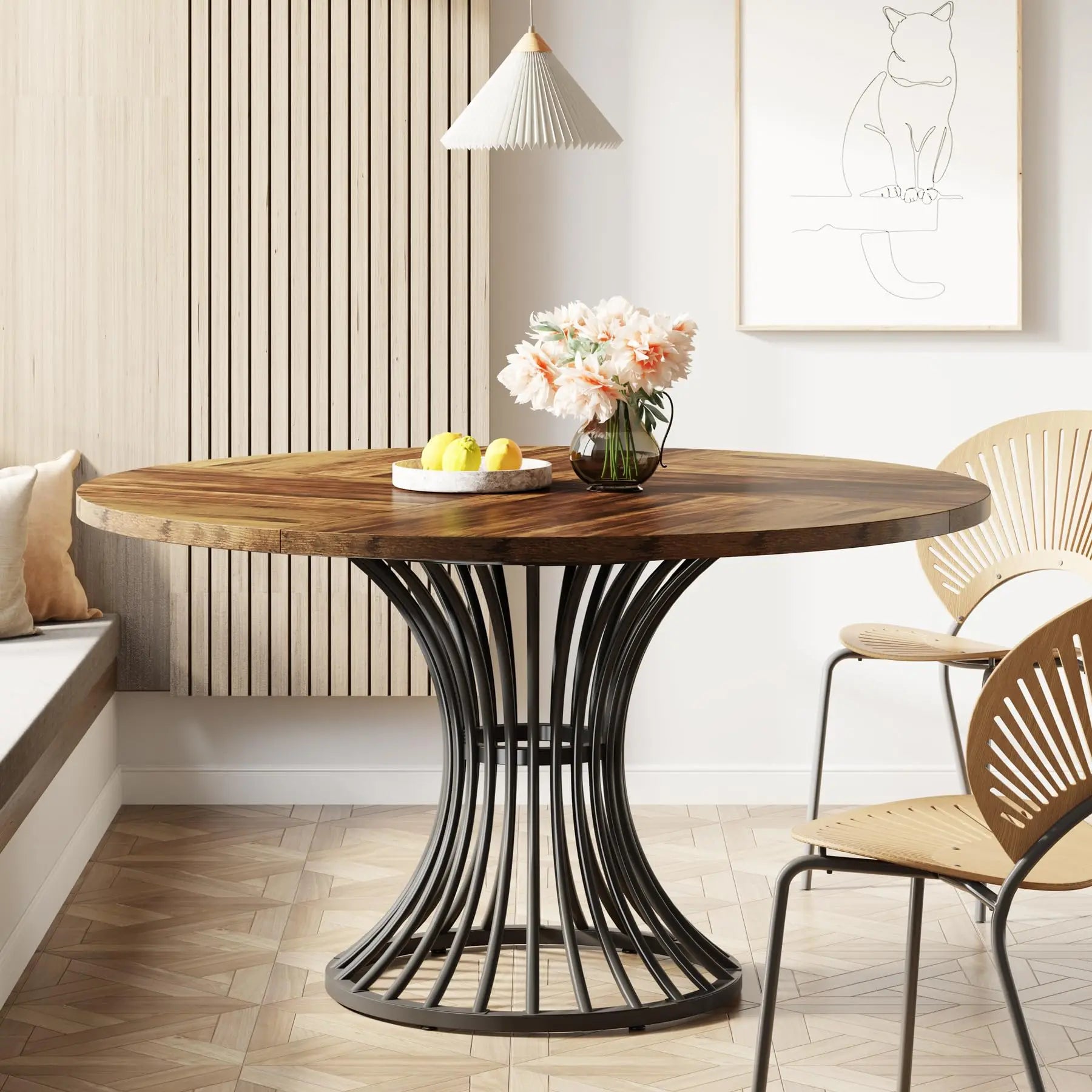 Round wooden table with black metal base in a modern interior setting