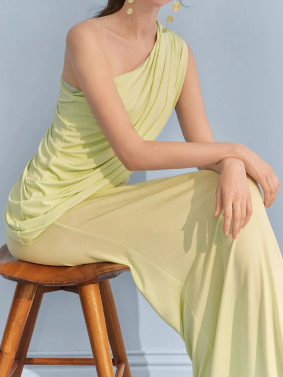 Seated view of one-shoulder draped maxi dress