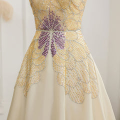 Close-up of the beadwork and butterfly details on the beige evening gown.  Golden Atelier