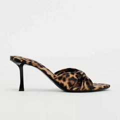  Close-up of the bow knot and leopard print pattern on the high heel slippers. Golden Atelier 2