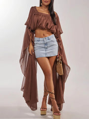 Brown draped square neck crop top with a denim mini skirt and platform heels.