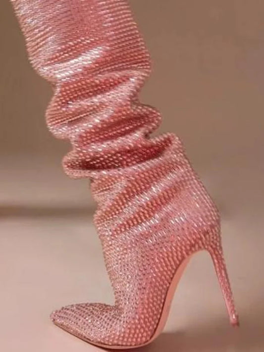 Close-up of a pink crystal embellished over the knee boot shaft.