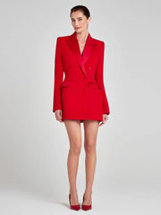 Woman wearing a red suit on a white background